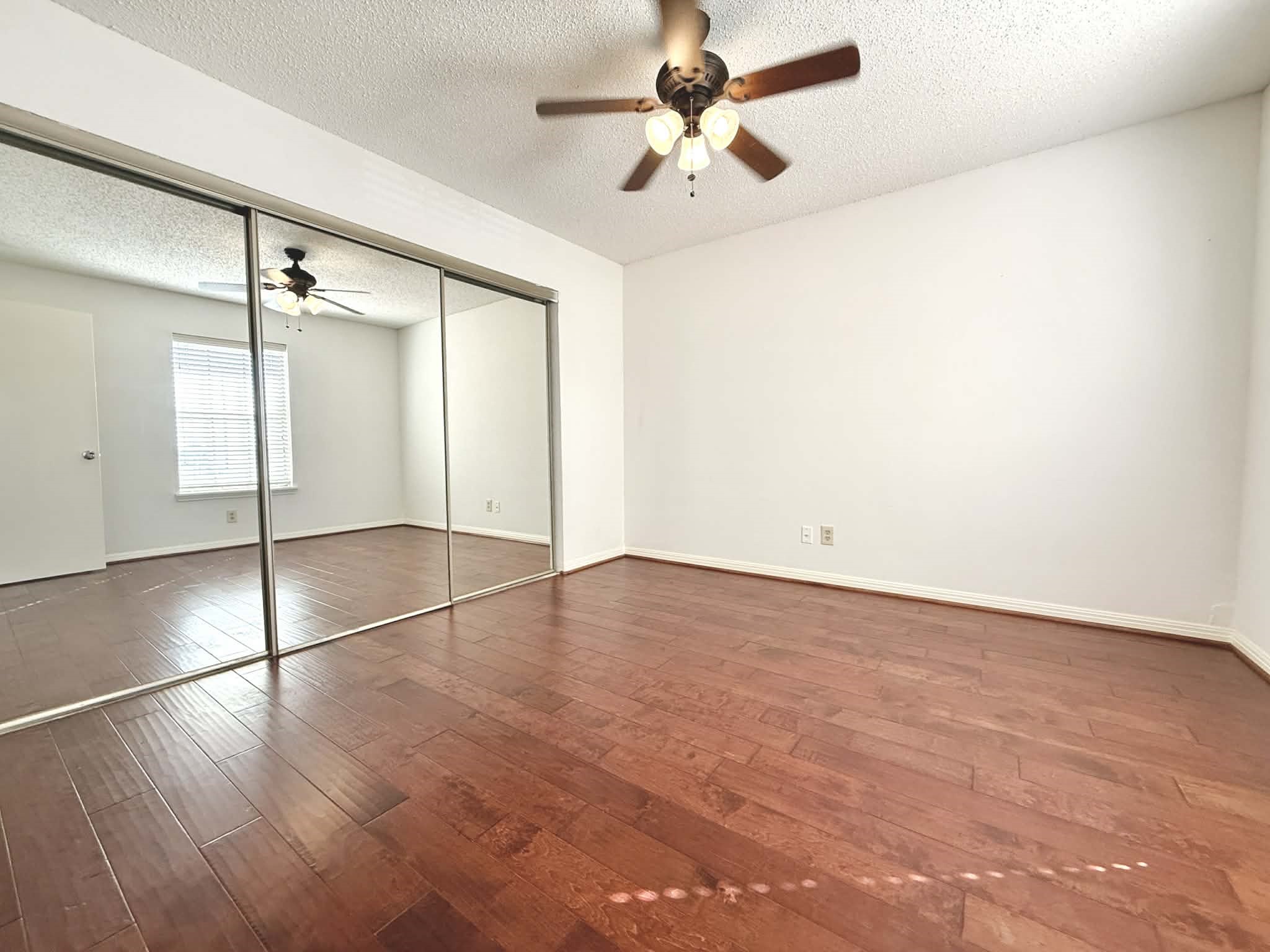 12100 Overbrook Lane, Unit 17D Houston, TX 77077 - Photo 8 of 22 wooden floor in an empty room