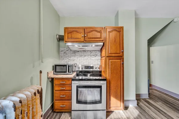 a kitchen with stainless steel appliances granite countertop a stove and a refrigerator