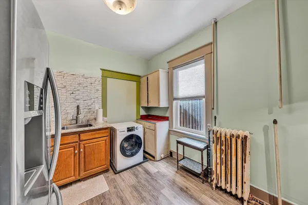 a kitchen with a refrigerator a stove top oven and a refrigerator