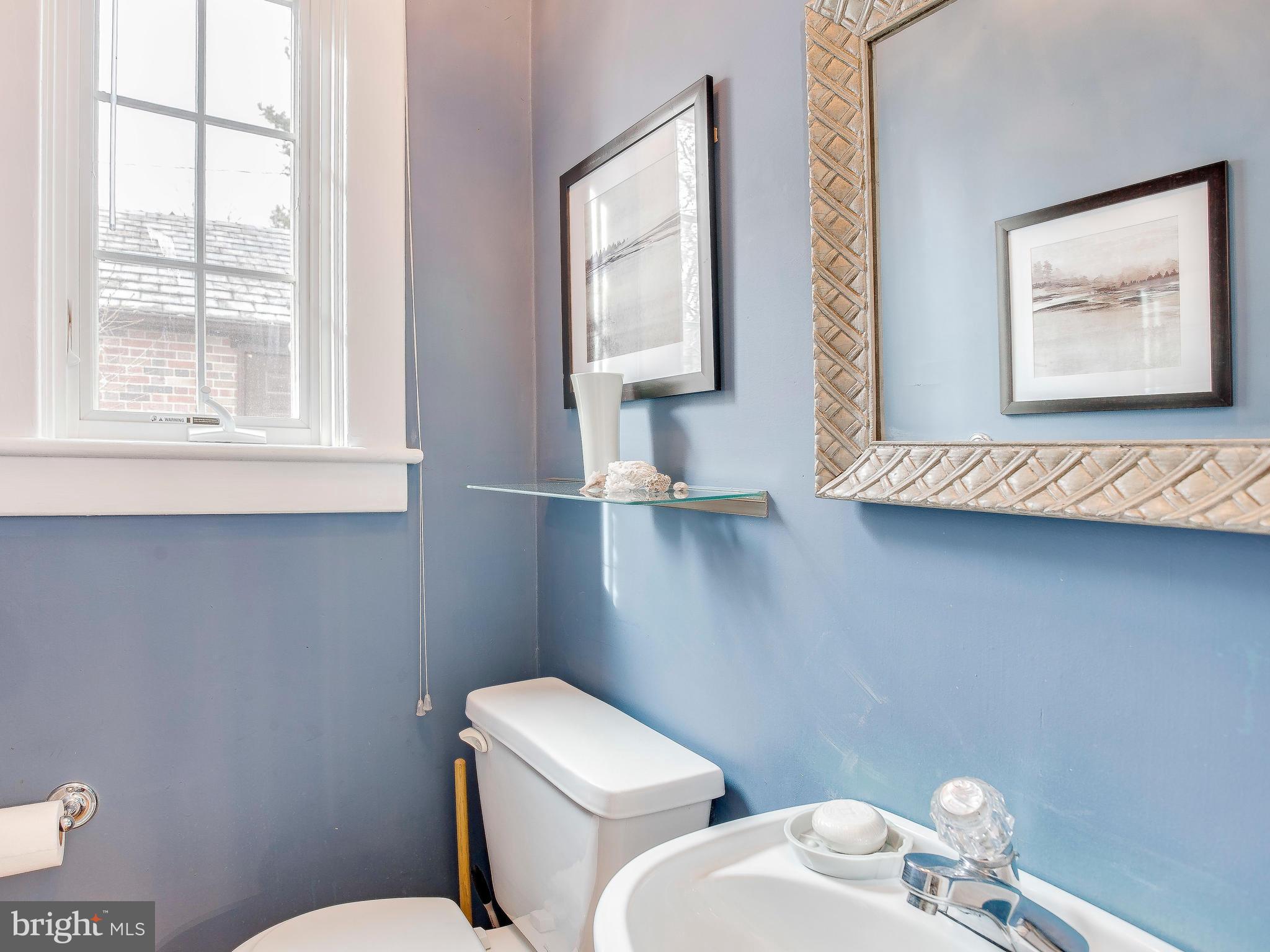 4424 Wickford Road Baltimore, MD 21210 - Photo 14 of 29 a white toilet sitting next to a bathroom sink