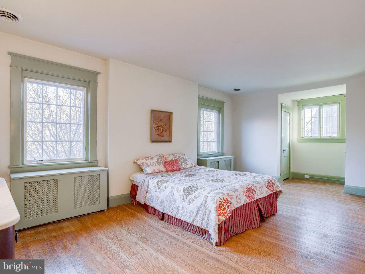 4424 Wickford Road Baltimore, MD 21210 - Photo 22 of 29 a bedroom with a bed and wooden floor