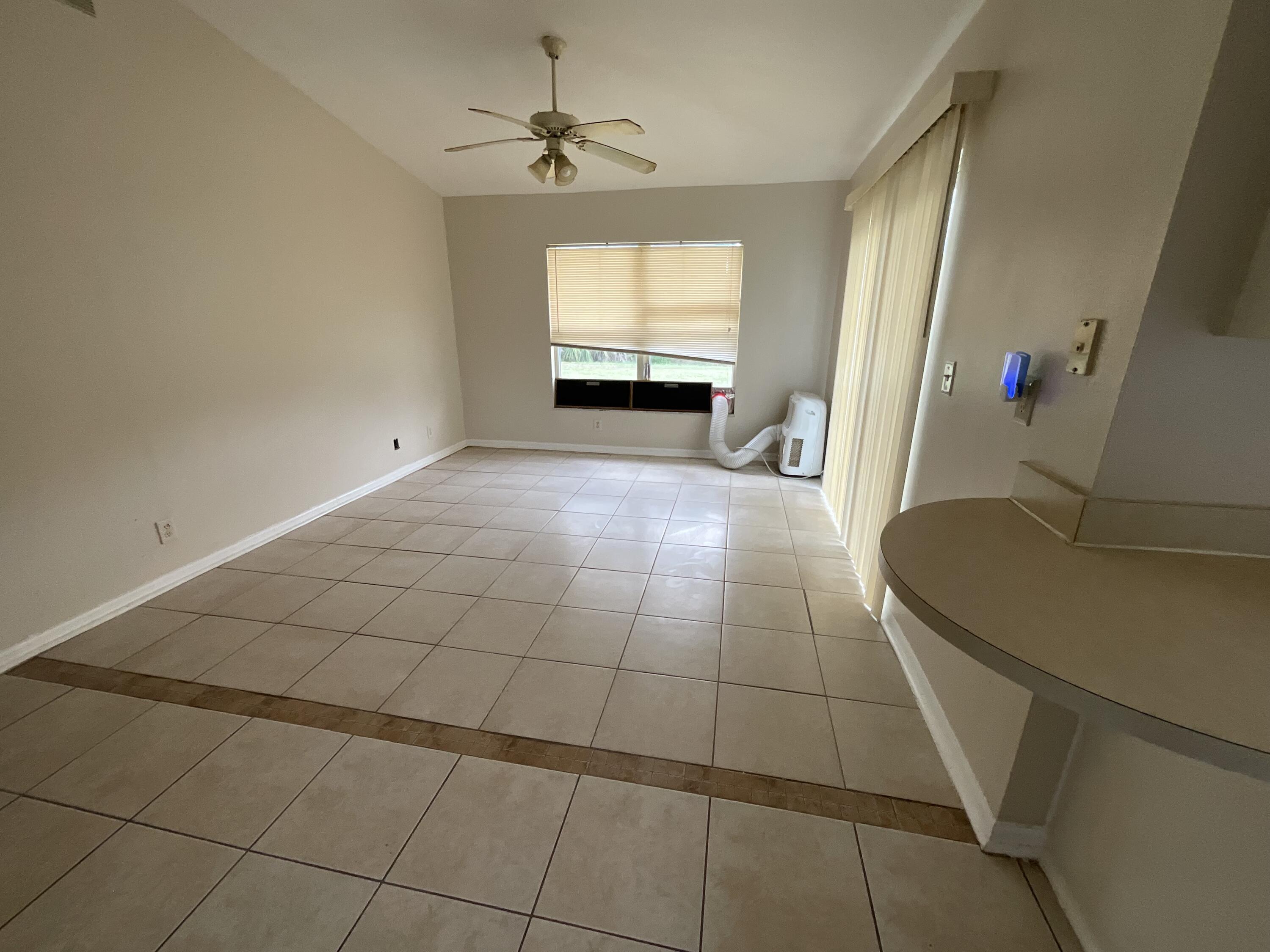 1002 Southwest Romaine Lane Port St. Lucie, FL 34953 - Photo 12 of 26 a view of an empty room with a window