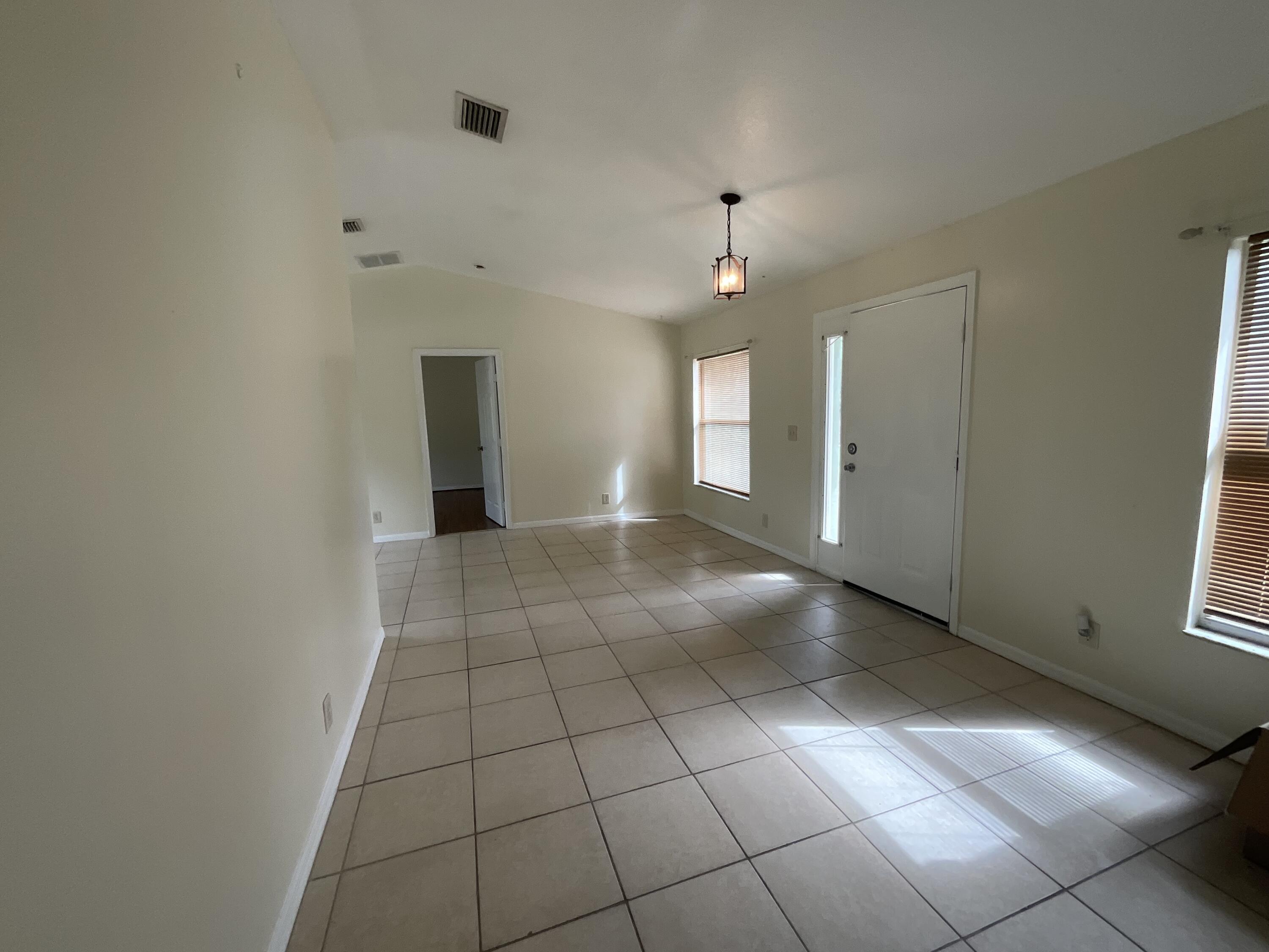 1002 Southwest Romaine Lane Port St. Lucie, FL 34953 - Photo 15 of 26 a view of a livingroom with an empty space and a window