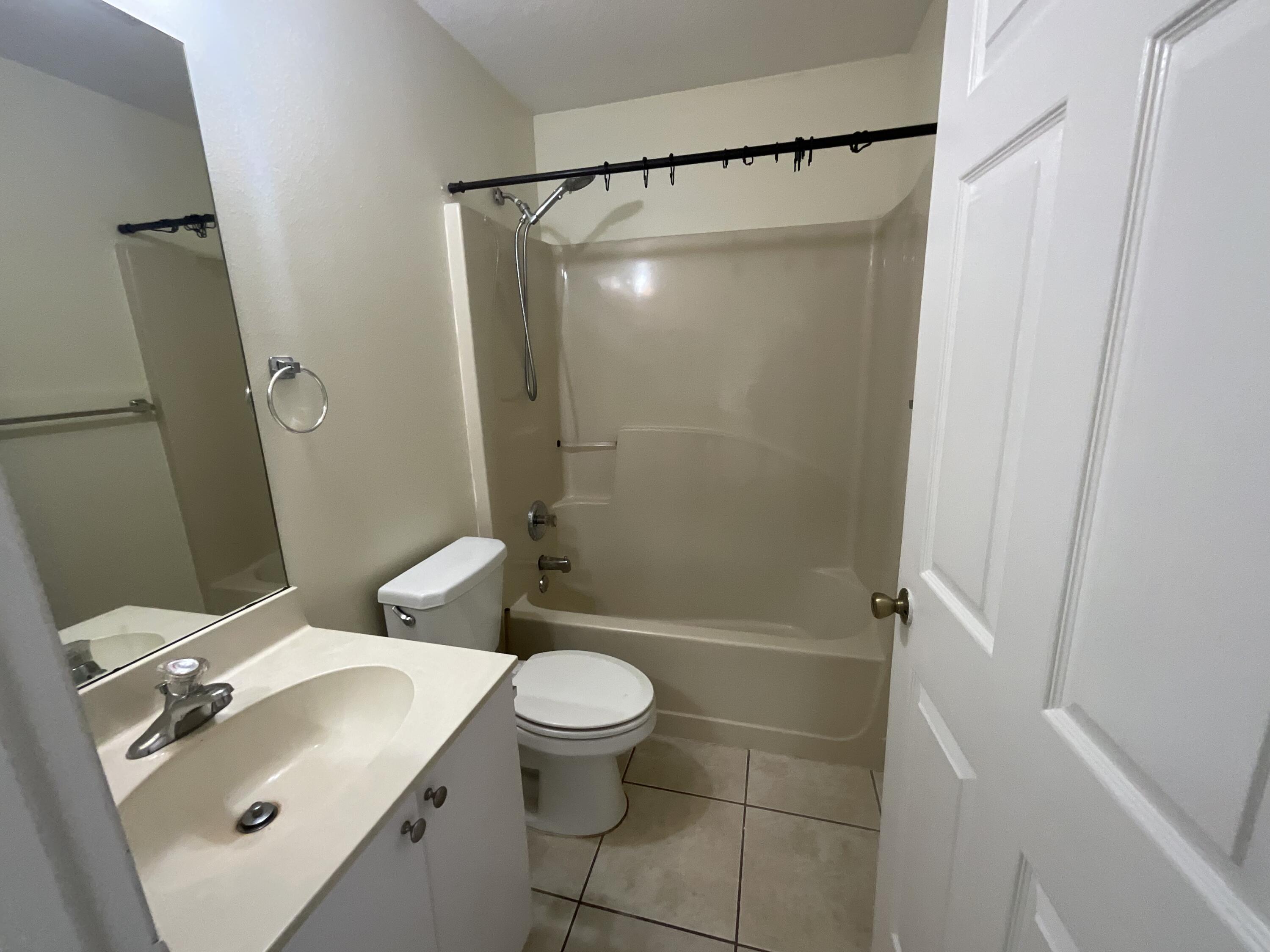 1002 Southwest Romaine Lane Port St. Lucie, FL 34953 - Photo 21 of 26 a bathroom with a sink toilet and shower