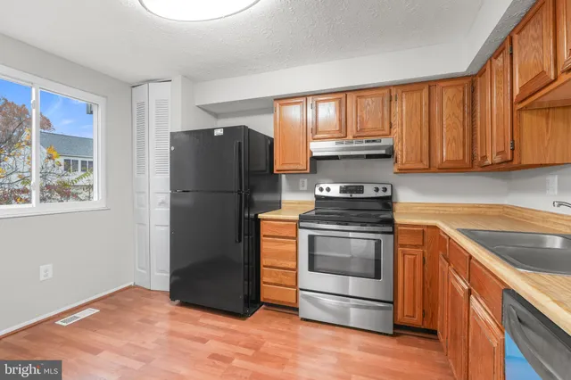 a kitchen with a refrigerator and a stove