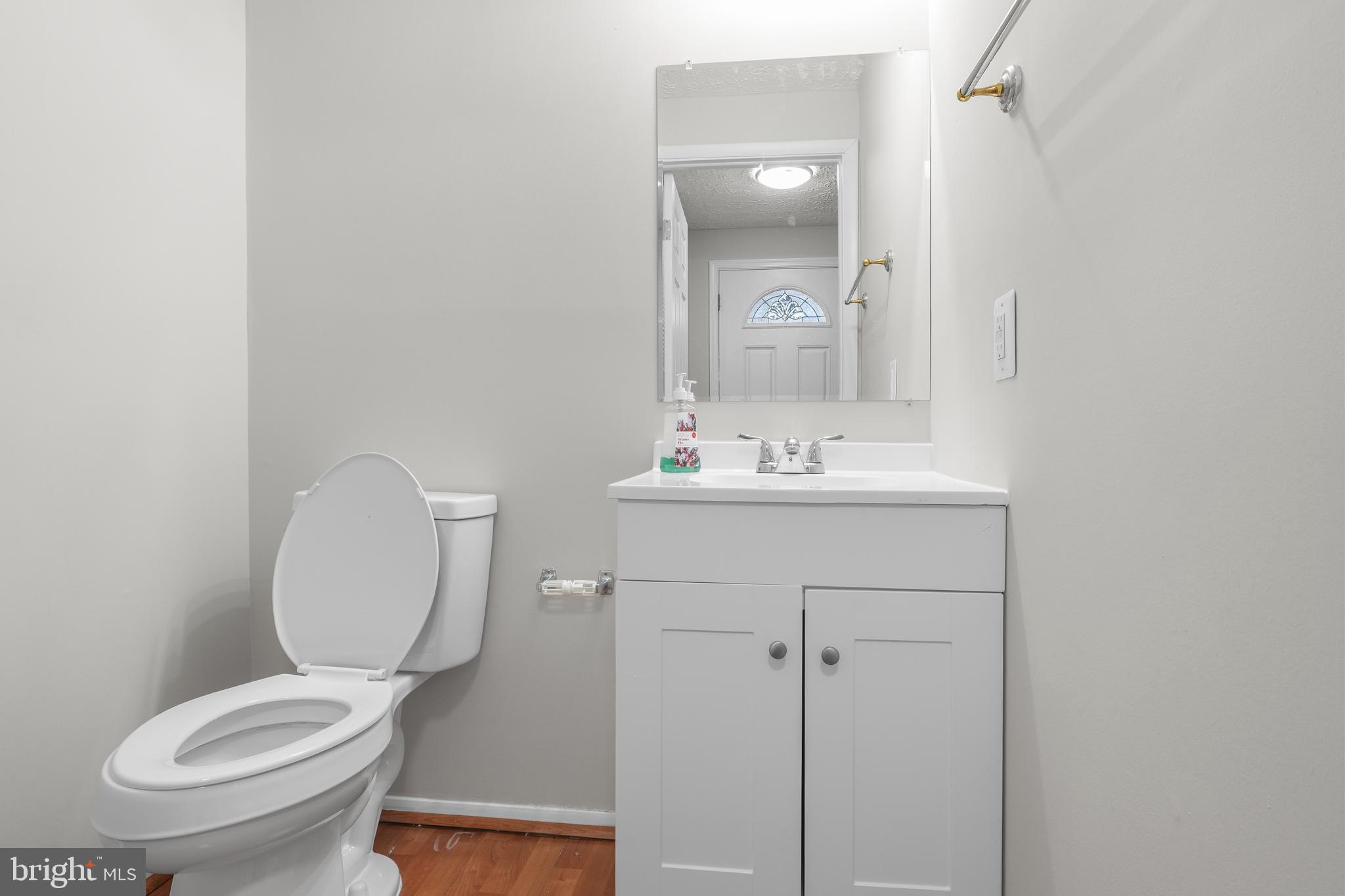 9998 Tuscarora Road Randallstown, MD 21133 - Photo 7 of 21 a bathroom with a toilet sink vanity and mirror