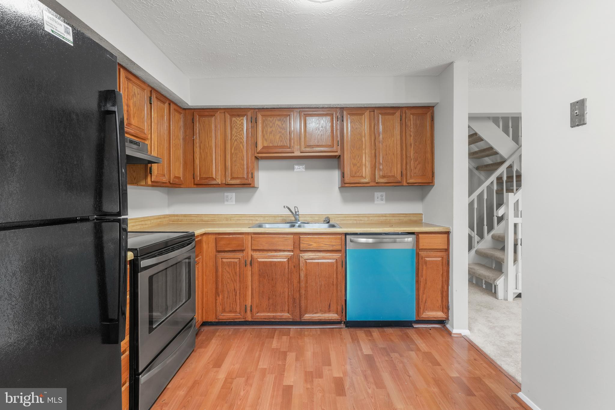 9998 Tuscarora Road Randallstown, MD 21133 - Photo 8 of 21 a kitchen with stainless steel appliances granite countertop a refrigerator sink and cabinets