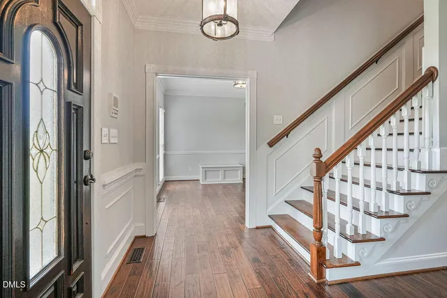 a view of a dining room with furniture wooden floor and chandelier
