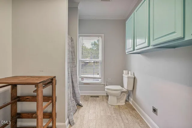 a bathroom with a granite countertop double vanity sink a mirror and a shower
