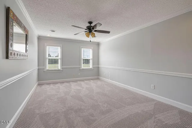 a view of a house with a backyard and sitting area
