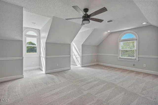 a view of a green field with wooden fence