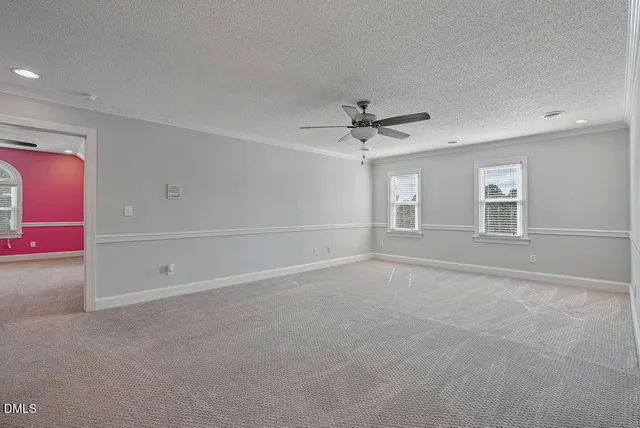 a view of an house with backyard and a tree