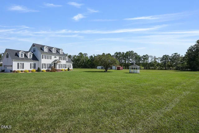 a view of a hallway with wooden floor and stairs