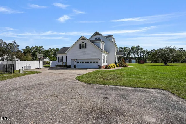 a kitchen with stainless steel appliances granite countertop a sink cabinets and wooden floor