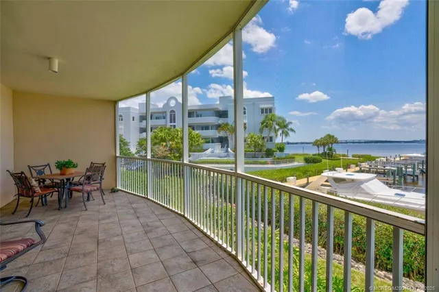 a view of a chairs and table in patio with a yard