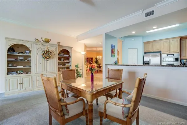 a dining room with furniture and wooden floor