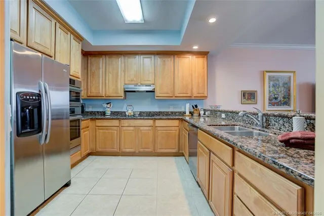 a kitchen with stainless steel appliances granite countertop a sink and cabinets