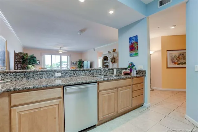 a kitchen with granite countertop a sink and cabinets