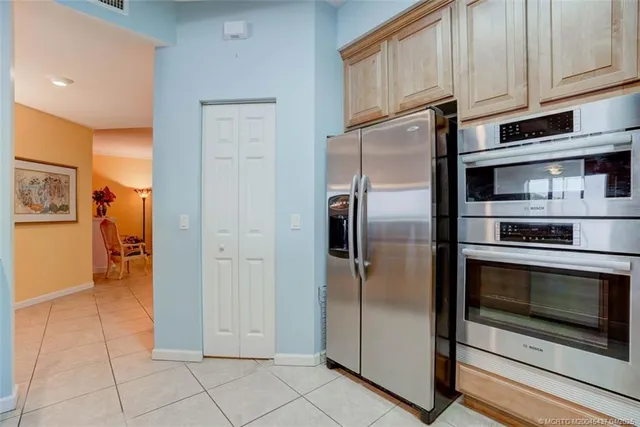 a kitchen with stainless steel appliances granite countertop a refrigerator and a stove top oven