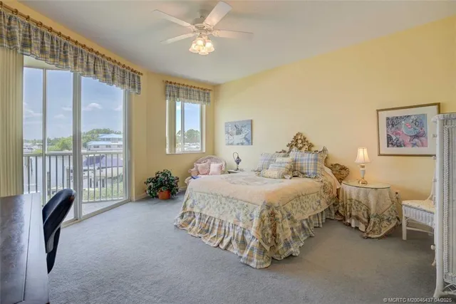 a spacious bedroom with a bed and a chandelier