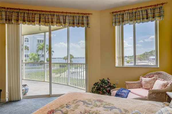 a bedroom with a bed and glass door