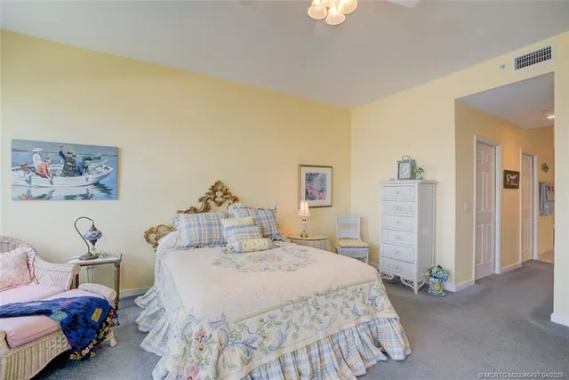 a spacious bedroom with a bed and a chandelier