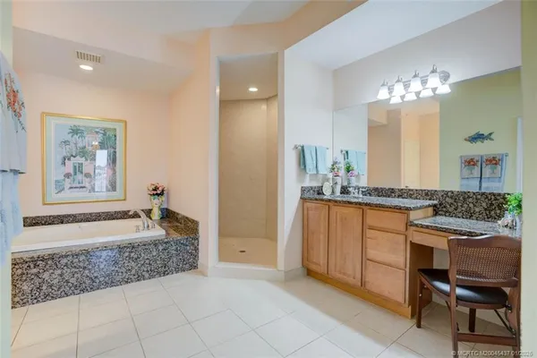 a spacious bathroom with a granite countertop sink and a mirror