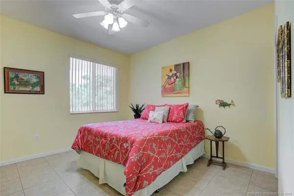 a bedroom with a bed and a painting on the wall