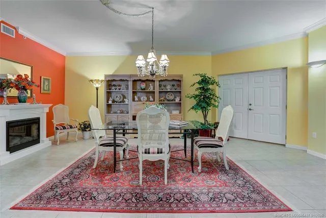 a living room with furniture a flat screen tv and a floor to ceiling window