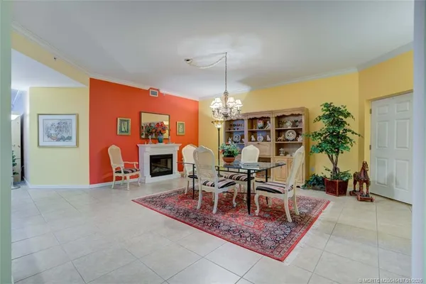 a living room with furniture a dining table and a fireplace