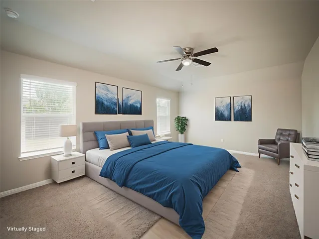 a bedroom with a bed a couch and a window