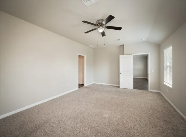 a view of a livingroom with a ceiling fan and window