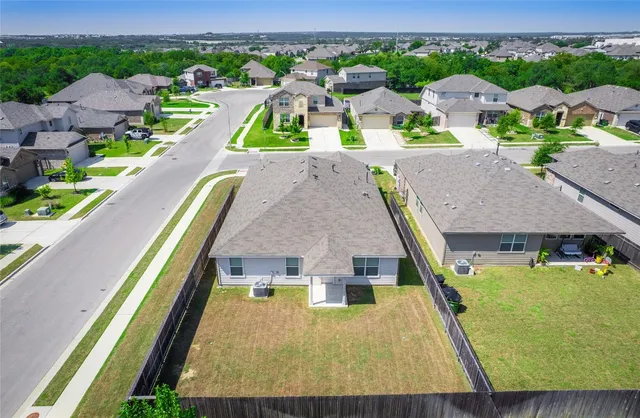 an aerial view of a house with swimming pool