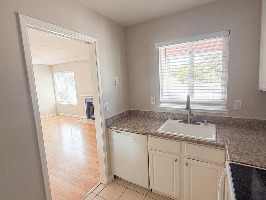 84 Rancho Drive, Unit H San Jose, CA 95111 - Photo 3 of 10 a en suite bathroom with a granite countertop sink and a window