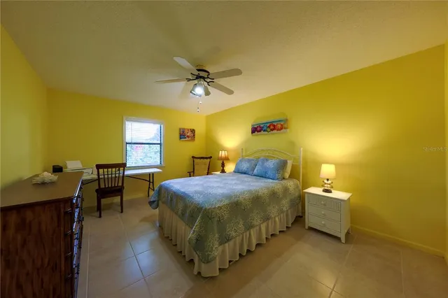 a bedroom with a bed and a table in it