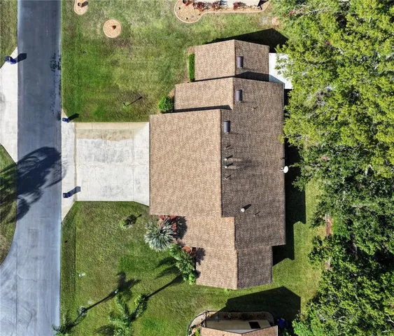 an aerial view of a house with a yard