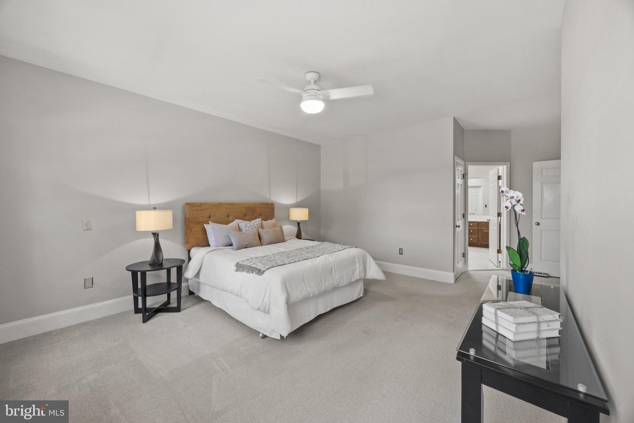 3403 Hidden River View Road Annapolis, MD 21403 - Photo 19 of 50 a bedroom with a bed and a chandelier