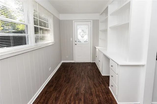 a view of a hallway with wooden floor and staircase