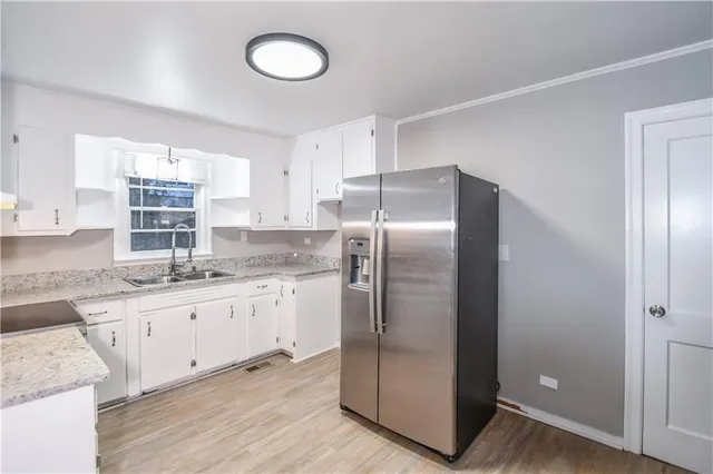 a kitchen with stainless steel appliances granite countertop a refrigerator and a sink