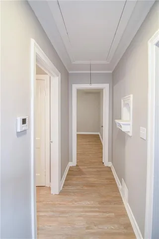 a view of a hallway with wooden floor