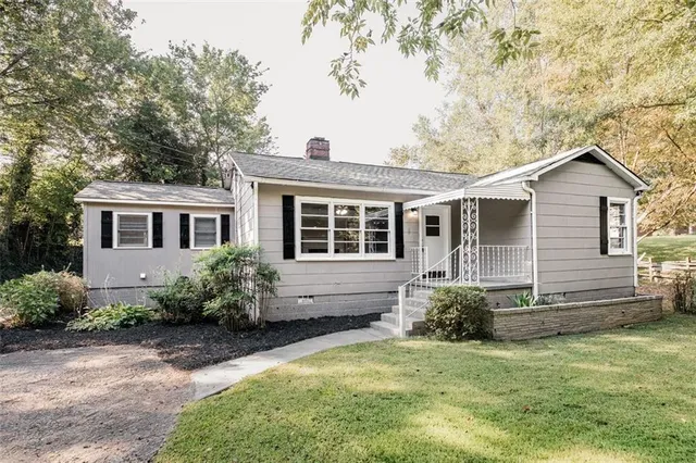 a front view of a house with a garden