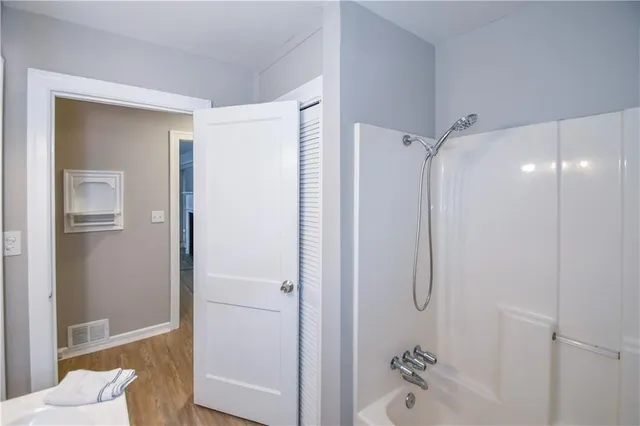 a bathroom with a shower and a tub