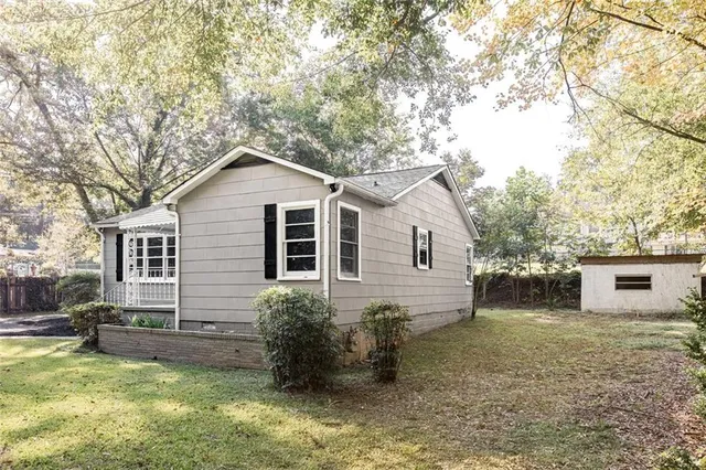 a view of a house with a yard and sitting area