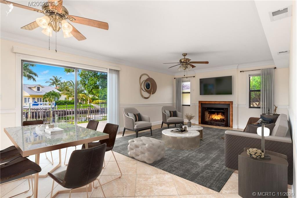 1239 Southwest Dyer Point Road Palm City, FL 34990 - Photo 12 of 34 a living room with furniture and a fireplace
