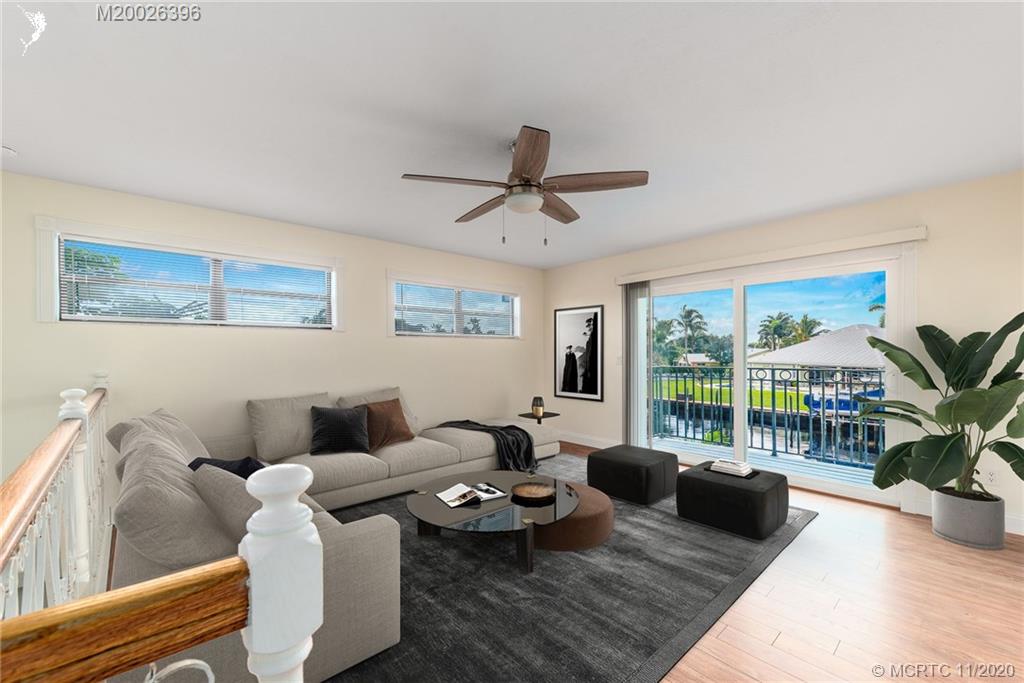 1239 Southwest Dyer Point Road Palm City, FL 34990 - Photo 17 of 34 a living room with furniture and a large window