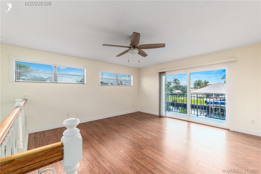 1239 Southwest Dyer Point Road Palm City, FL 34990 - Photo 18 of 34 a view of an empty room with a window