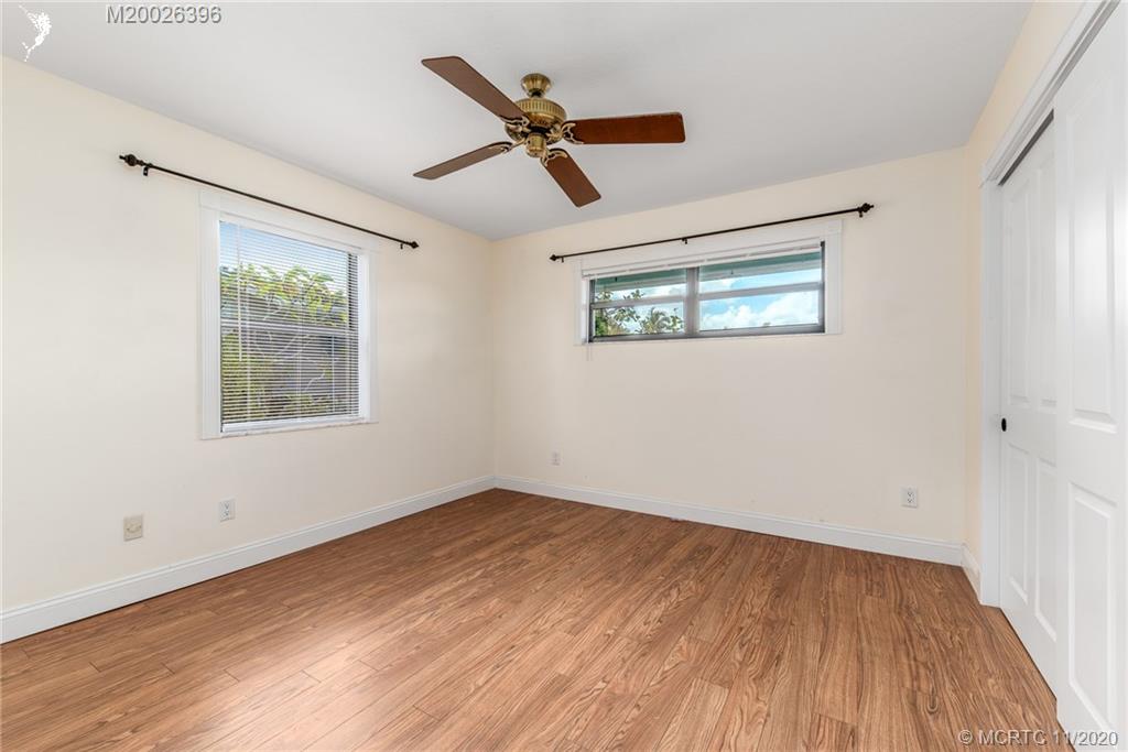 1239 Southwest Dyer Point Road Palm City, FL 34990 - Photo 21 of 34 a view of empty room with wooden floor and ceiling fan