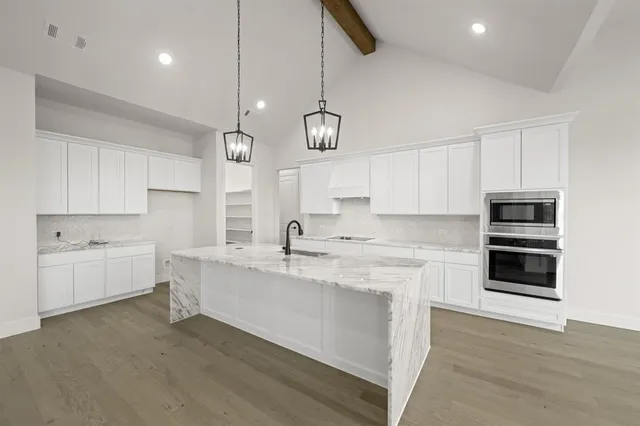 a kitchen with a sink stainless steel appliances and cabinets