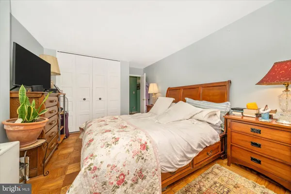 a bedroom with a bed and a flat screen tv