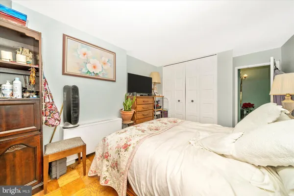 a bed room with a bed and a television